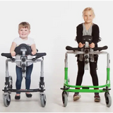 Two children standing behind metal rolling walker frames on a clean white studio background. The child on the left wears a white shirt and blue jeans, using a black walker frame.